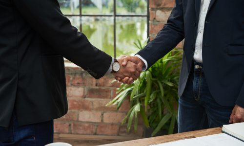 Cropped image of business colleagues shaking hands to confirm deal